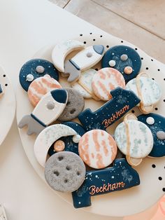 decorated cookies are sitting on a white plate