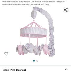 a pink and white baby crib mobile with elephants hanging from it's sides