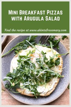 a pizza with arugula and cheese on it sitting on top of a plate