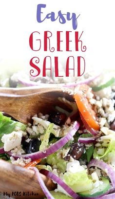 an easy greek salad with feta cheese, olives and red onions in a wooden bowl