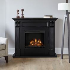 a living room with a fire place in the center and a chair next to it