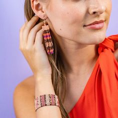 Embrace the vibrant spirit of Jaipur with the Billie Mixed Horizontal Stripes Fringe Earrings! Featuring Peach, Bronze, Coral, and Magenta hues, these earrings are a playful addition to your jewelry collection. The intricate design with tiny glass beads offers a delicate and feminine look that's perfect for any occasion. --DETAILS-- 3.3" L, .62" W Handmade by skilled artisans in India Hypoallergenic nickel + lead-free brass hardware These accessories are made by human hands. A slight variation i Fusion Style Colorful Beads Jewelry For Festival, Pink Bohemian Beaded Earrings For Festive Occasions, Bohemian Pink Beaded Earrings For Festive Occasions, Pink Festival Jewelry With Latkans, Pink Latkan Festival Jewelry, Festive Bohemian Pink Beaded Earrings, Bohemian Pink Jewelry With Dangling Beads, Pink Bohemian Jewelry For Festive Occasions, Festive Adjustable Beaded Earrings With Colorful Beads