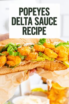 a person holding a sandwich with chicken and lettuce on it that says pope's delta sauce recipe