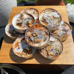 several bowls filled with food sitting on top of a wooden table