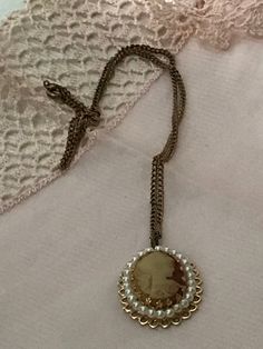 "Small costume jewelry faux cameo necklace. Center cameo surrounded by faux pearls on a gold filled chain . Could be a necklace for a child or a child in a wedding party, or prop in a costume shop. Measurements are; 16 1/2\" from end to end. Feel free to convo me with any further questions. Thank you for your interest.l" Jewelry Faux, Providence Ri, Cameo Necklace, Bridesmaid Flowers, Costume Shop, Jewelry Vintage, Gold Filled Chain, A Child, Costume Jewelry