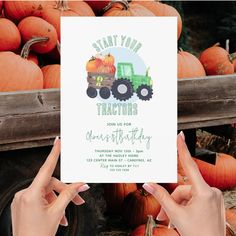 two hands holding up a card that says, start your tractors adventure birthday with pumpkins in the background