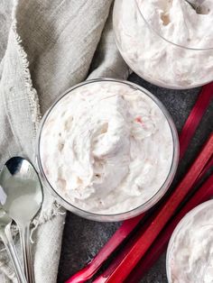 two bowls filled with whipped cream next to red chopsticks