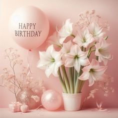 a vase filled with white flowers next to a balloon