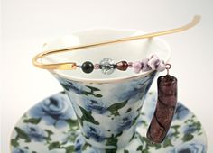 a cup with some beads on it sitting on a saucer