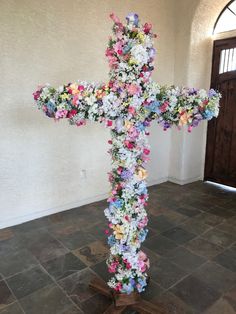 a cross made out of flowers in a room