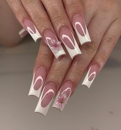 These nails feature a delicate pink base with chic white French tips, adorned with intricate floral designs that evoke the essence of summer blooms.  🌸Click on the image to shop our trending Korean Gel Polish this season.  🌸Credit: nailzbycassiee on Instagram 🌸summer nails, Korean gel polish, pink nails, white French tips, floral nail art, summer blooms, trendy nails, nail design, summer manicure, long nails, glossy nails, nail trends, elegant nails, nail inspiration, nail fashion, Instagram nails, nail art ideas, summer nail polish, chic nails, nail beauty. White French Acrylic Nails, Pink And White French, White French Tip Nails With 3d Flower, Long White French Tip Nails, White Elegant Nails, French With 3d Flower, White Wedding Nails, Nail Ideas Summer 2024, White Snowflake Nails