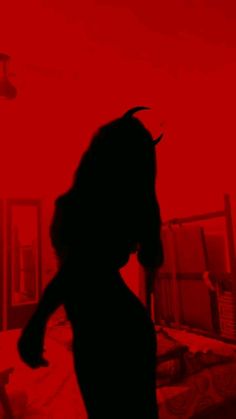 the silhouette of a woman in a red room