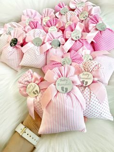 several pink and white bows are on a furnishing with tags attached to them