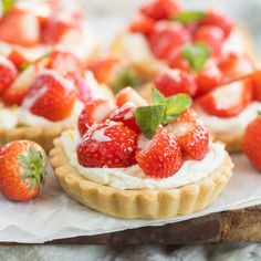 strawberry shortcakes with whipped cream and fresh strawberries on the top are ready to be eaten