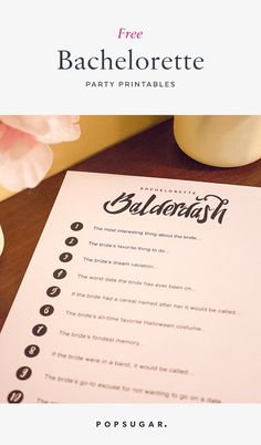 a table with a menu and flowers on it, next to a vase filled with pink flowers