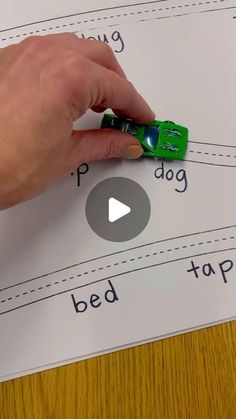 a person is writing on a sheet of paper with the word bed top written in green