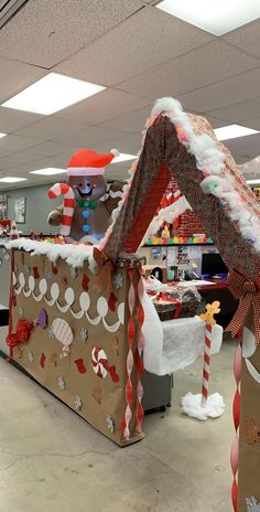 an inflatable gingerbread house decorated for christmas with candy canes and decorations