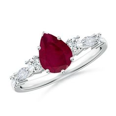 a ring with a pear shaped ruby stone and three diamonds on the band, set in white gold