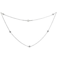 This exquisite Tiffany & Co. Diamond by the Yard necklace is crafted in platinum and features 5 diamonds in 4.5mm round bezel settings. The round brilliant G VVS2-VS1 diamonds weigh an estimated 0.90 carats. Made in United States circa 2010s. Measurements: 0.18" (4mm) width, 16" (40.6cm) length. Approximate retail price $9,500. Tiffany Smile Diamond Necklace, Diamond Necklace Tiffany, Diamond By The Yard, Diamonds By The Yard, Platinum Necklace, Tiffany Diamond, Vs1 Diamond, Elsa Peretti, Tiffany And Co