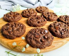 chocolate chip cookies on a cutting board with flowers