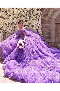 a woman in a purple dress is sitting on a chair with flowers around her neck