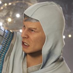 a close up of a person wearing a hood and holding a hair dryer in his hand