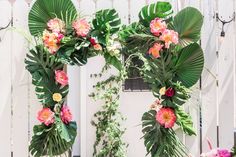 two floral archways with green leaves and pink flowers