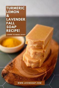 a wooden cutting board topped with soap next to a bowl of turment and lemon