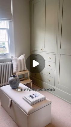 a white bench sitting in the middle of a room next to a radiator