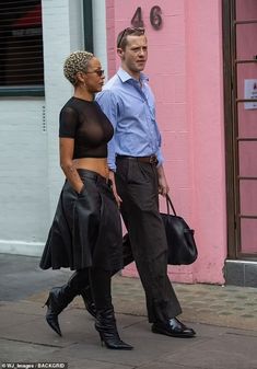 a man and woman walking down the street