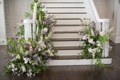 some flowers are sitting on the steps in front of a set of banisters