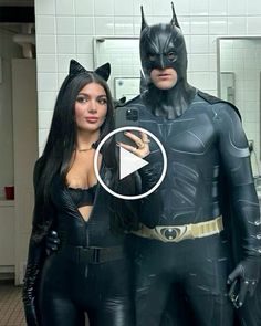 two women dressed up as batman and catwoman posing for a photo in the bathroom