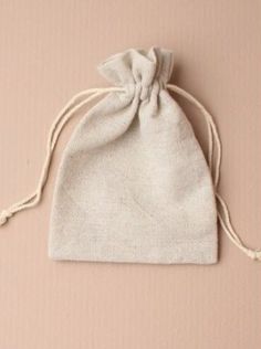 a small draws bag sitting on top of a pink surface