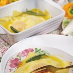 two bowls with food on them and one has a fork in it, while the other is empty