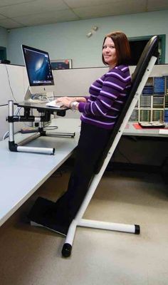 a woman sitting at a desk using a computer