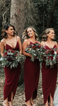 the bridesmaids are all wearing red dresses and holding greenery in their hands