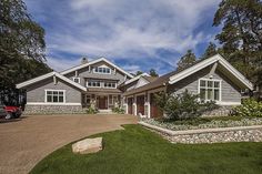 a large house with lots of windows and landscaping