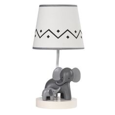 an elephant lamp on a white base with a black and white lampshade over it