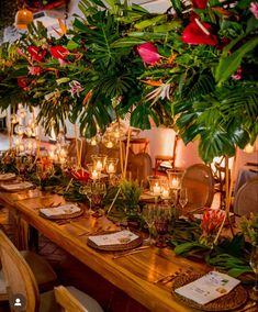 a long wooden table topped with lots of greenery