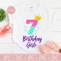 a birthday shirt with the number seven and a crown on it, next to some pink shoes