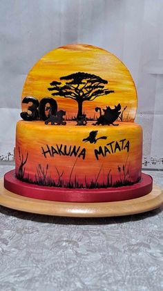 the cake is decorated with an image of two cats and a tree in the background