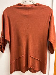 This season, look top-notch in the Midwest Top! Featuring a burnt orange hue, you'll be sure to stand out from the crowd. And with a v neck, quarter length sleeves, and a relaxed fit, you'll enjoy maximum comfort with maximum style. Get ready to look (and feel!) amazing! This top is available in X-Small, Small and Medium! Curated from cotton, modal, and spandex. To care for this top machine wash in cold water with like colors and tumble dry on low heat. This top is a fun twist on a basic tee mak