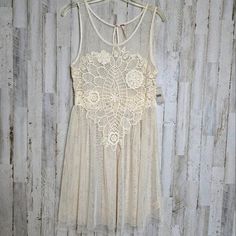 Free People Crochet Appliqué Mesh Dress M Boho Sheer Ivory Creme NWT Cream Sleeveless Lace Dress With Lace Trim, Beige Sleeveless Dress With Lace Work, Sleeveless Beige Dress With Lace Work, White Bohemian Sheer Dress, White Sheer Bohemian Dress, Off White Lace Patchwork Summer Dress, Off White Lace Patchwork Dress For Summer, Cream Flowy Dress With Lace Patchwork, Flowy Cream Dress With Lace Patchwork