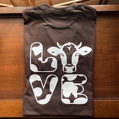 a t - shirt that says love with a cow on it