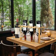 a wooden table topped with bottles of wine