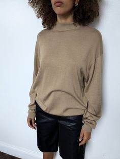 Camel mock neck oversized sweater. No materials listed. Feels like wool and silk blend.  *As is: Small snags on front and back under neck Measurements:  Length: 25" Bust: 43" Sleeve length: 32" Sleeve circumfrence: 7"  Waist: 25"  Neck circumference: 16"  *measurements are taken seam to seam while lying flat.  *doubled for bust, waist and hips.  *model is a small/medium, around 5'8"  Follow along at @spaghetti_strap Pull Oversize, Oversized Pullover, Oversized Sweater, Mock Neck, Camel, Spaghetti Strap, Spaghetti, Adult Outfits, Sleeve Length