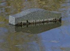 a memorial stone in the middle of a body of water that reads, to the very dear memory of 10 lake drive victoria