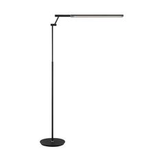 a black floor lamp on a white background with the light turned on and dimming