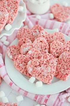 pink rice krispy treats on a plate with marshmallows