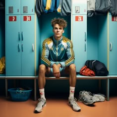 a man sitting on a bench in front of lockers